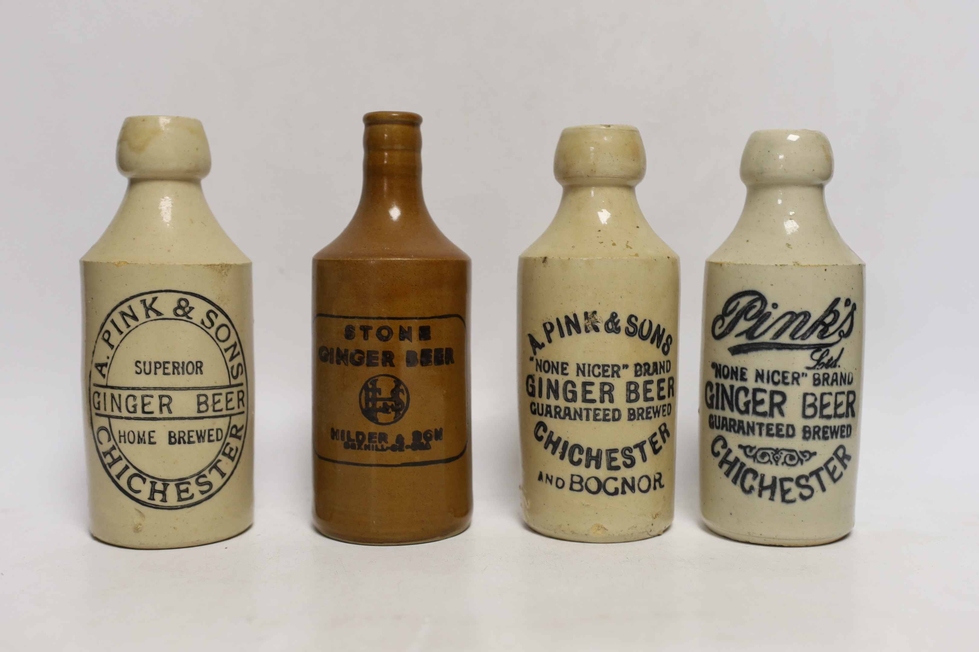 Early 20th century stoneware ginger beer bottles, six from Chichester and four others